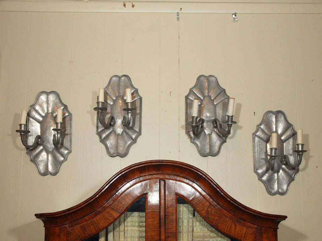 Set of four antique French pewter two-light wall sconces.