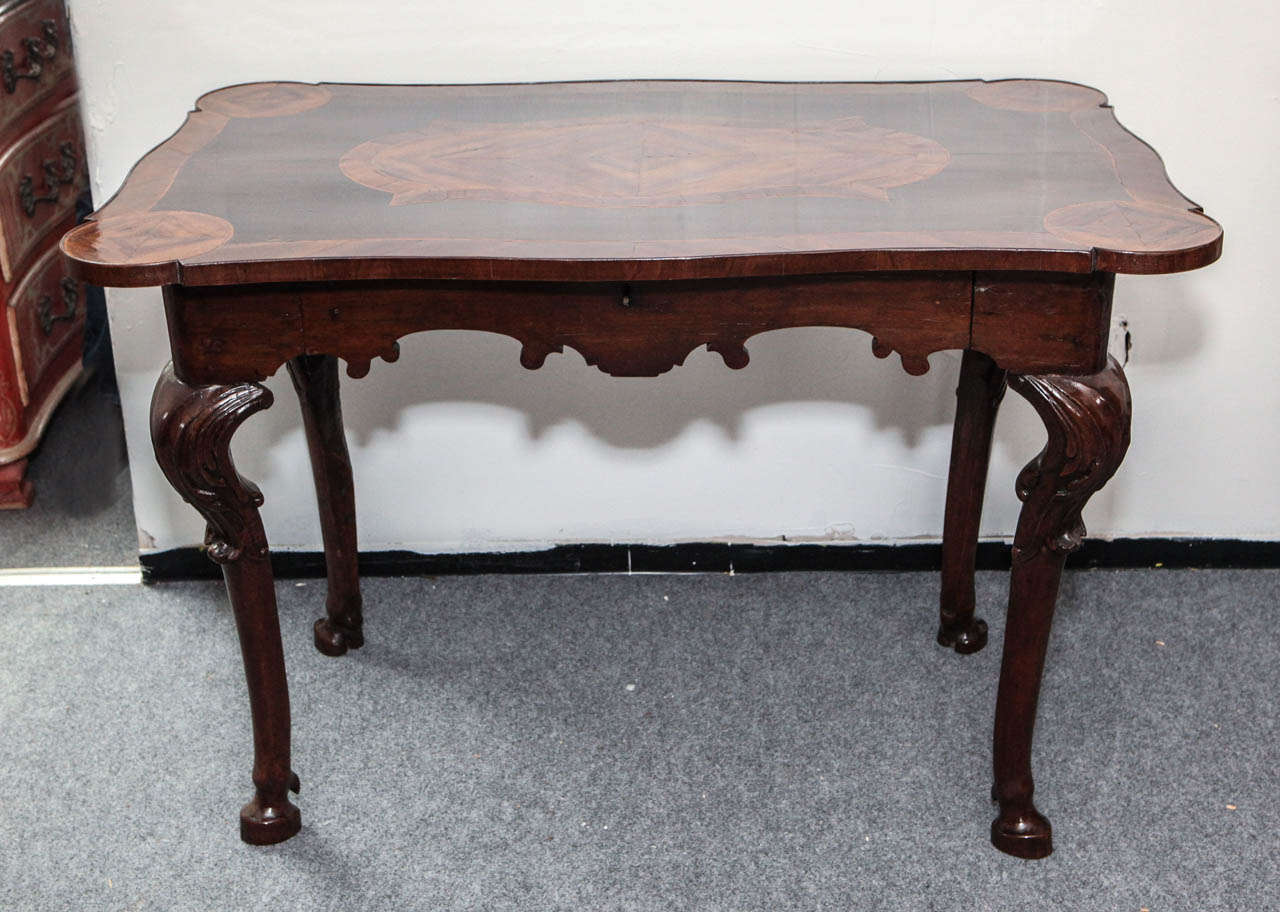Late 18th century inlaid, single-drawer, Tuscan table with scrolling apron and dew-claw, hoof feet.