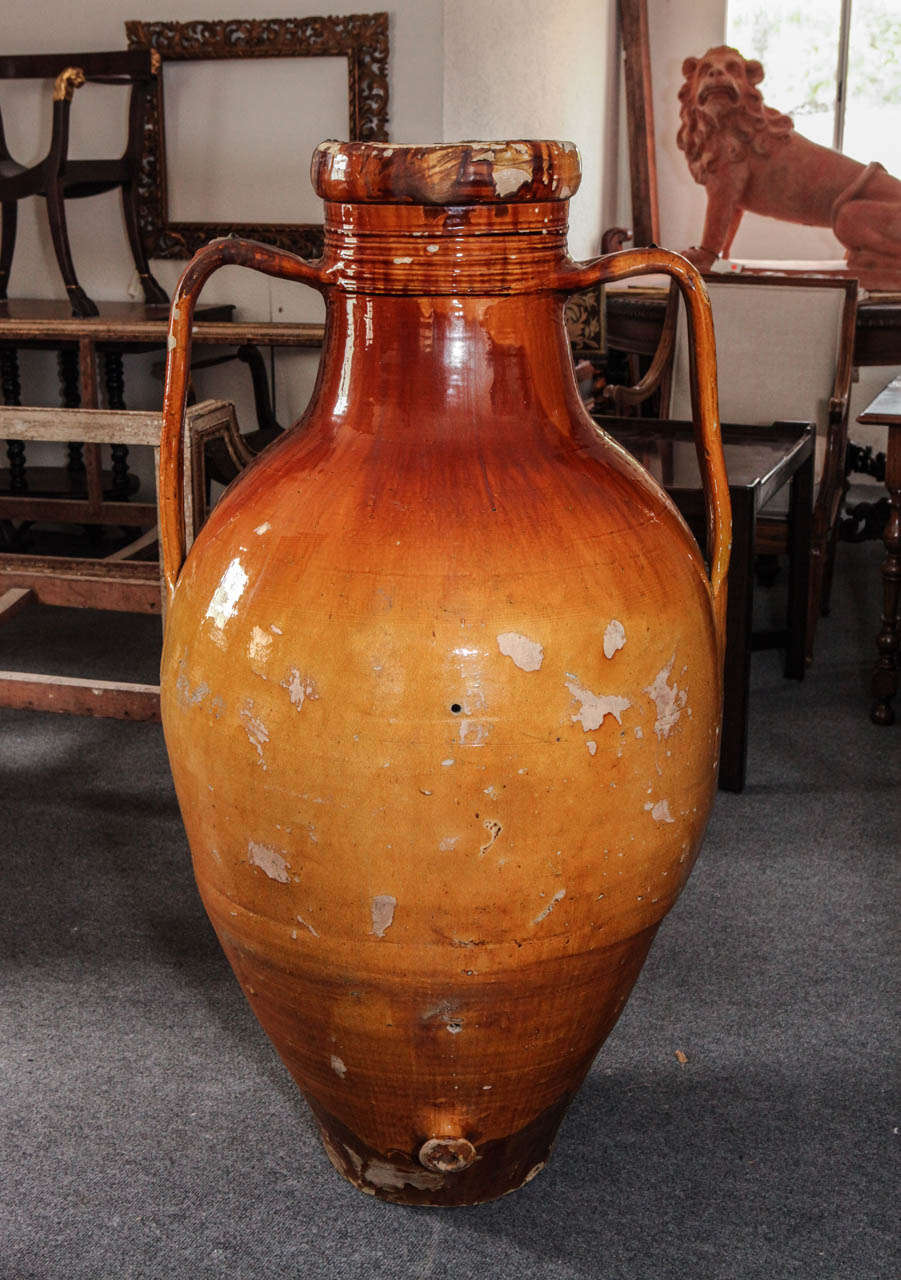 Large, hand-glazed, terracotta, Sicilian olive jug with two handles and a spout.