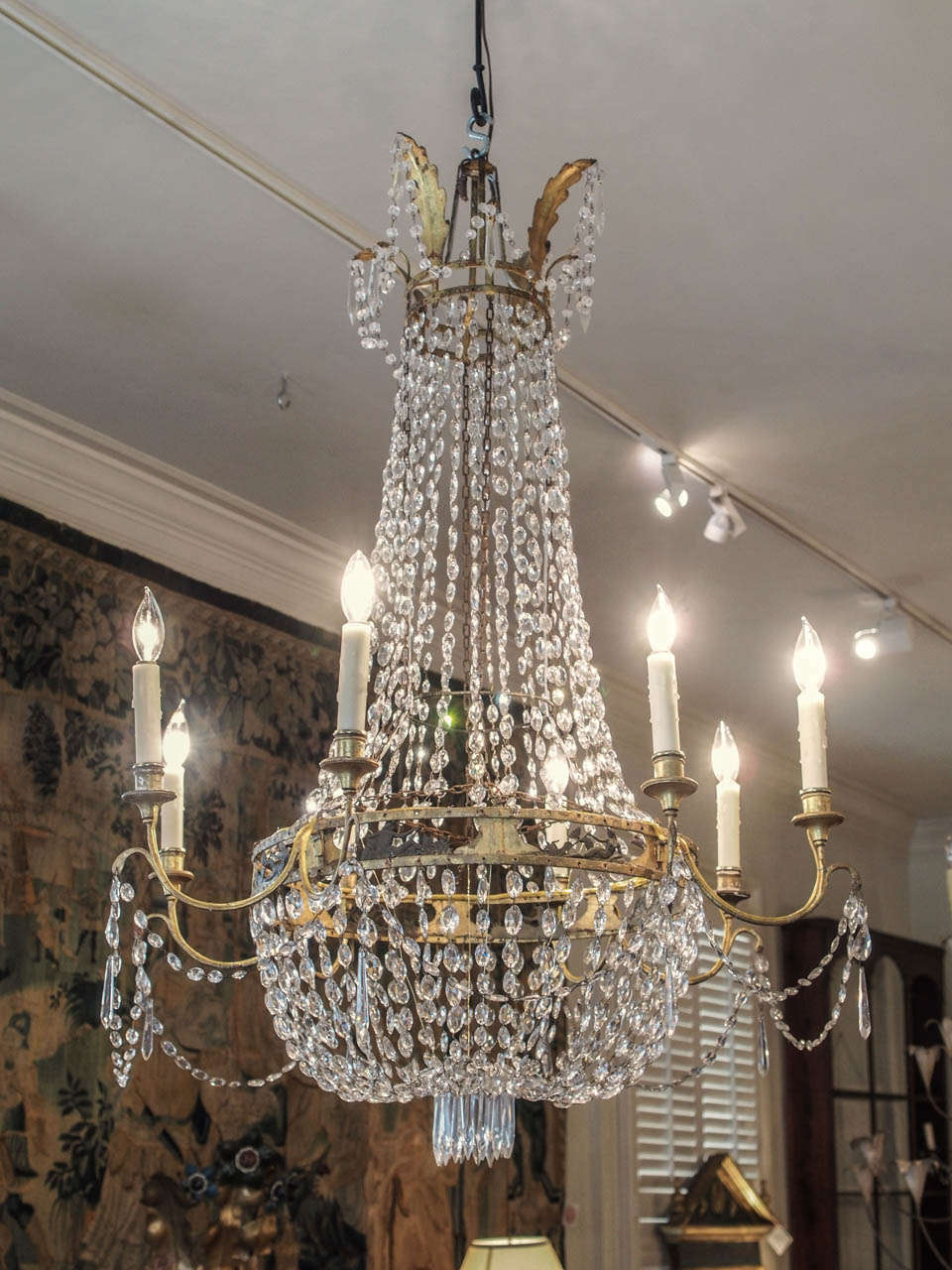 A large, 8 light neo-classical gilt iron basket form chandelier, the central ring pierced and having bas relief inserts of a recumbent Poseidon.    Wired to U.S. specifications.