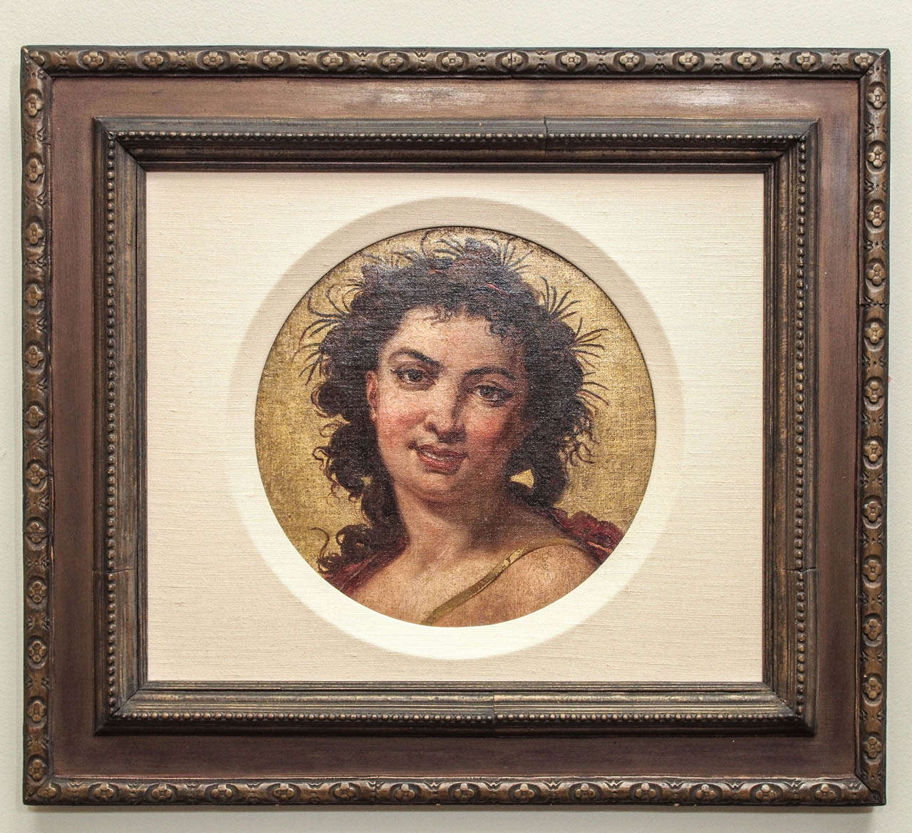 A late 18, early 19c. oil on canvas painting of a slightly gender ambiguous character, likely Diana, goddess of the hunt, with flora embellished hair and a leather strap for a quiver or box over her shoulder.  Finely woven canvas consistent with