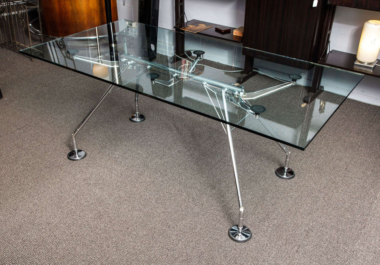 The Nomos table ,designed by Norman Foster in 1987 for Tecno.
Glass top and metallic base. Signed Tecno on the base.