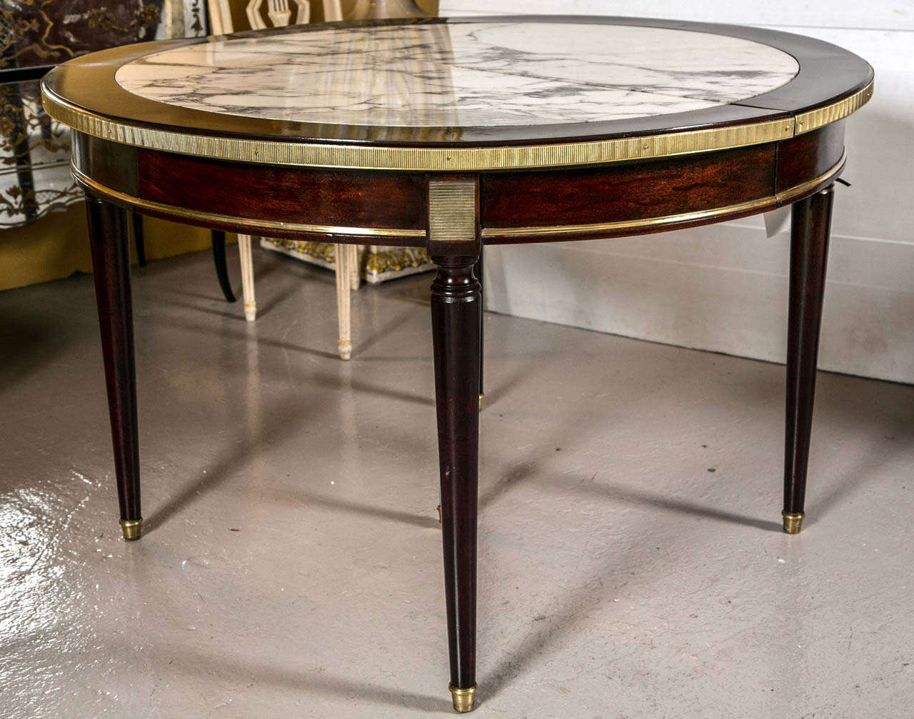 A Two Leaf Marble Top Dining Table by Maison Jansen