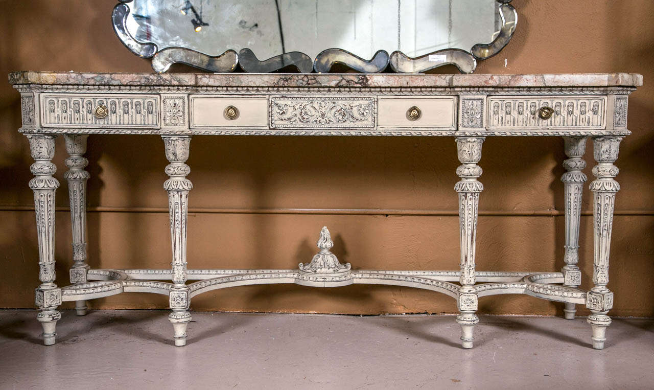 A stunning Swedish Decorated French Louis XVI Style Marble Top Sideboard / Console. This finely constructed piece having a group of six Louis XVI style tapering legs supported by a continuous undercarriage with a central carved flame. The fine