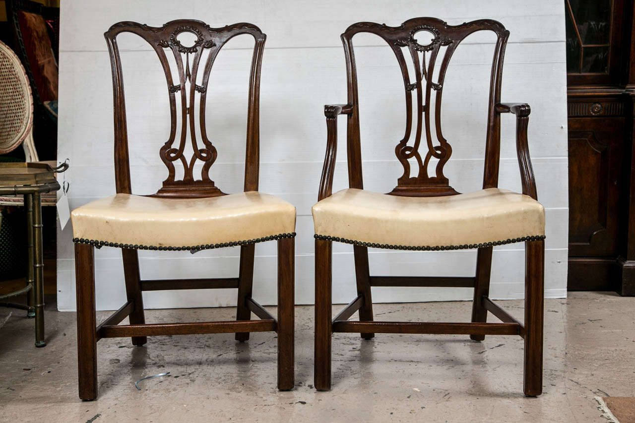 Set of eight Georgian dining chairs. The finely carved splat backs leading to a group of box stretchers forming the undercarriage. Armchairs: 23