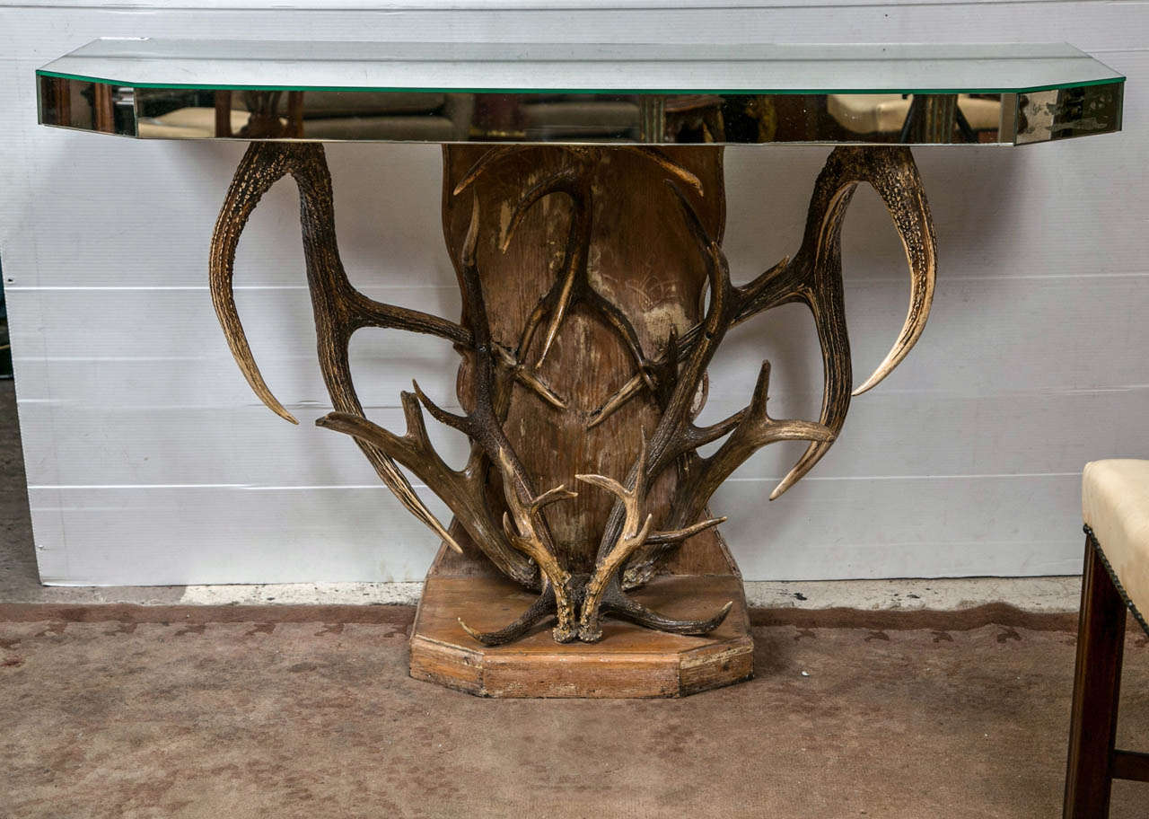 The wooden bottom and back brace support this real and unique antler based mirrored top console. Finely crafted in vintage secondary woods.