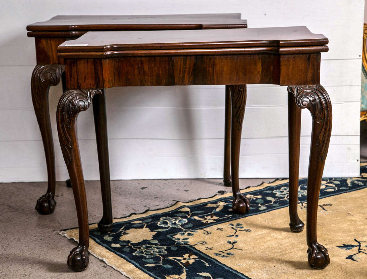 A spectacular pair of signed English George II card / game tables. The finely carved ball and claw feet leading to a carved cabriole leg supporting a boxed form apron. Both with fine mahogany flip tops reveling an tea table area on one and a card
