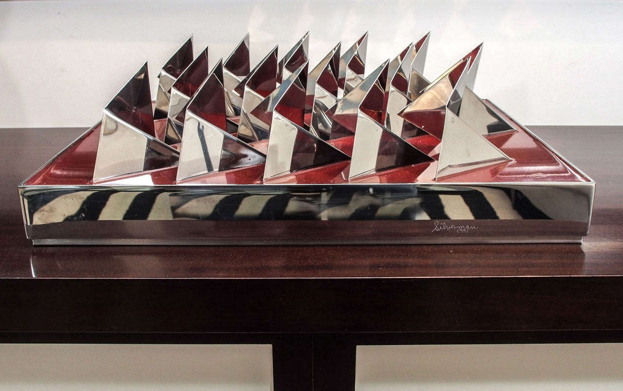 Sculpture in polished stainless steel and red enamel by noted New Orleans artist Arthur Silverman; signed 