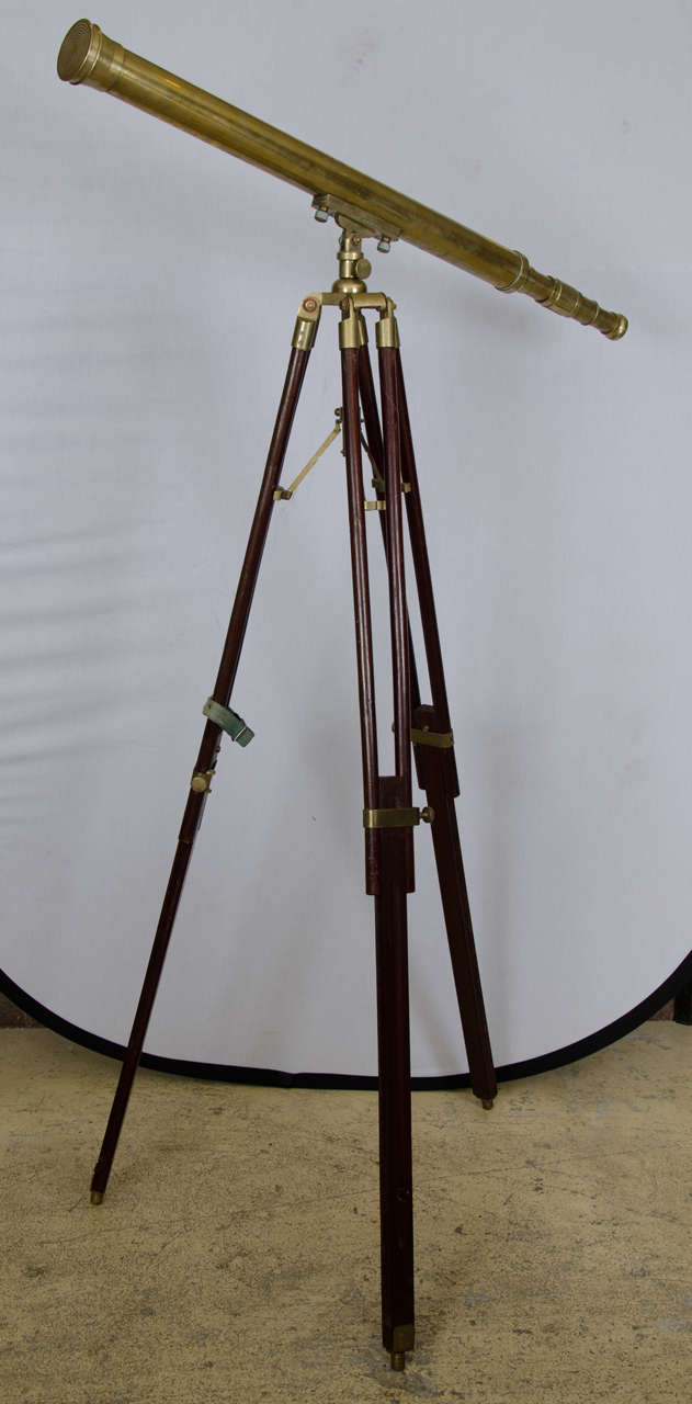 An antique telescope by Ross of London. This handsome brass telescope is fitted on an original brass and mahogany stand.