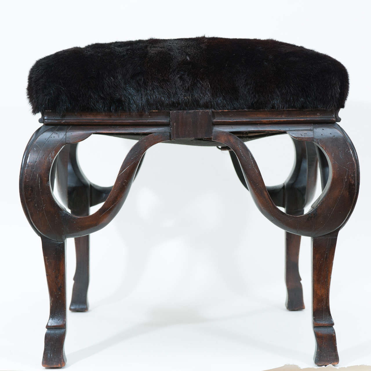 In the many years I have bought and sold antiques and vintage items I have never seen
such a unique and sculptural
wood bench as this! I suspect it is Italian and it's lines suggest an Art Nouveau
influence coupled with a hoof foot, yet it has a