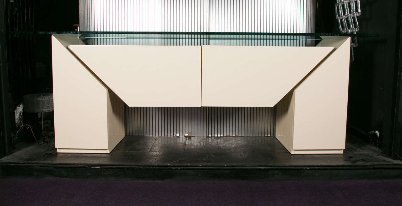 A buffet, 1980, ivory-white lacquer, thick glass top.