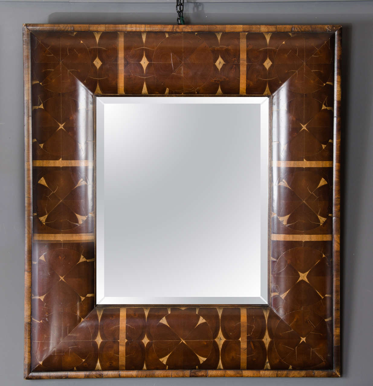 An extremely handsome late 20th century cushion mirror in the William and Mary style made from laburnum wood. The mirror measures 40 in, 102 cm high by 36 in, 92 cm wide with a depth of 2 in, 5 cm.