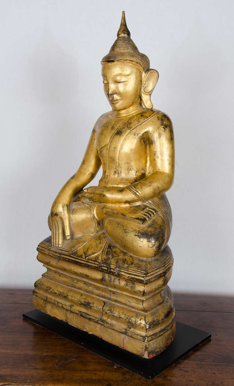 This outstanding Burmese carved gilt Buddha is of a well-proportioned size and very nicely carved, sitting in the ‘fire log’ yoga pose. He measures 17 in – 43 cm wide, 10 in – 26 cm deep and 34 in – 86 cm in height.