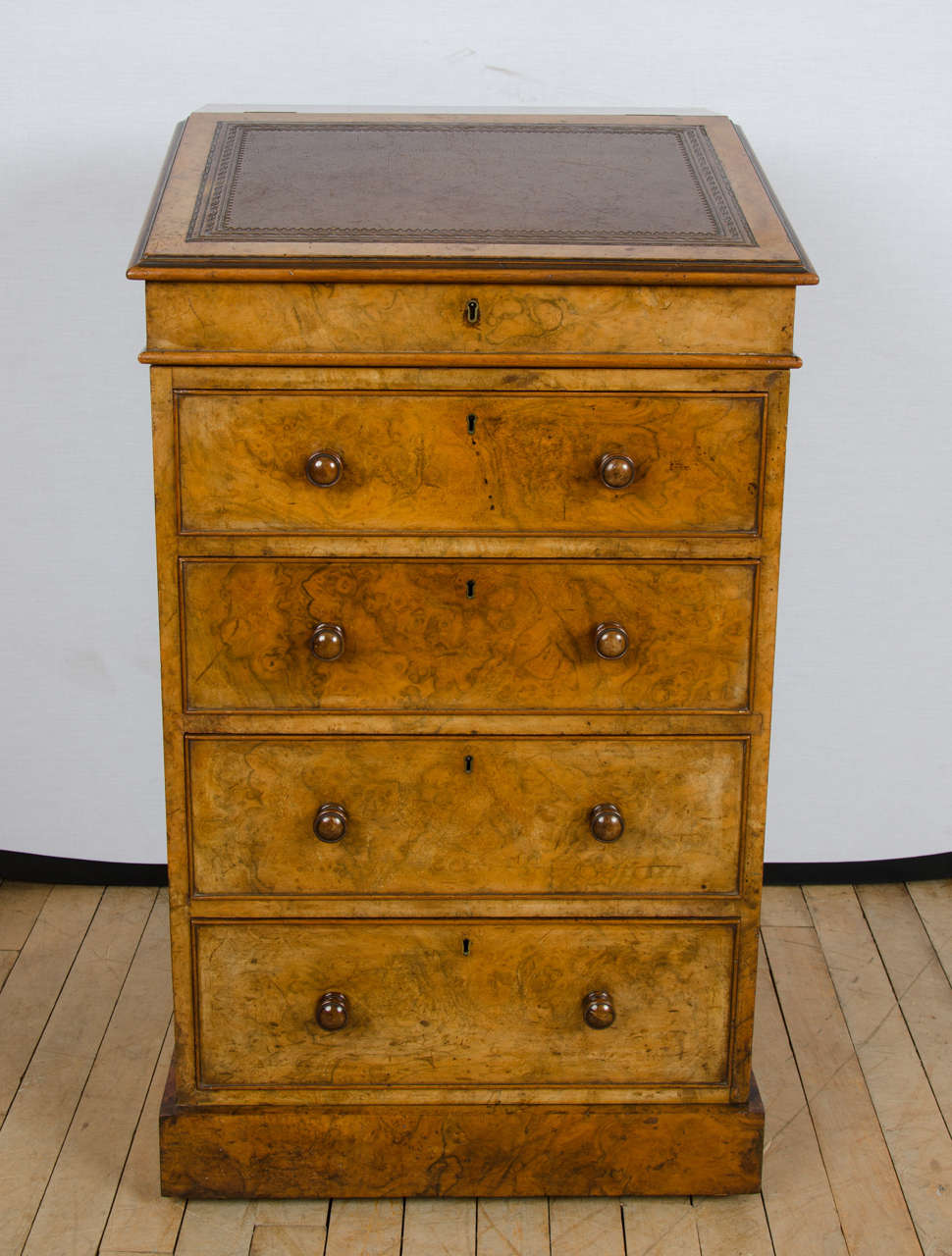A superb quality mid-19th century burr walnut Davenport signed with London makers Hindley & Sons, 154 Oxford Street. The writing slope on the Davenport twists around to allow for leg room and the drawers are all cedar lined, both attributes to a