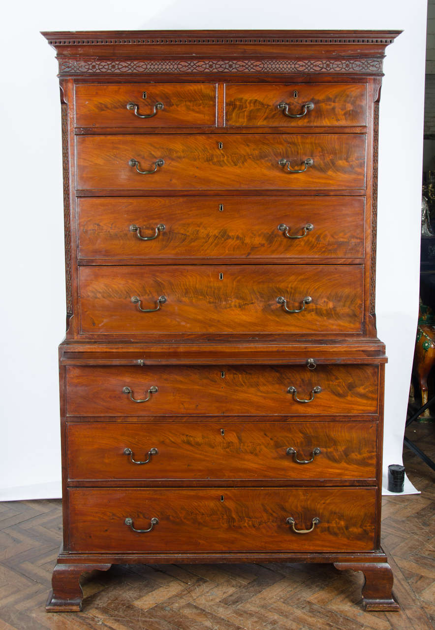 A very good quality Chippendale period mahogany chest on chest, having a dental cornice, canted corners with blind fretwork, a brushing slide, original brass handles, oak lined drawers and raised on ogee bracket feet.