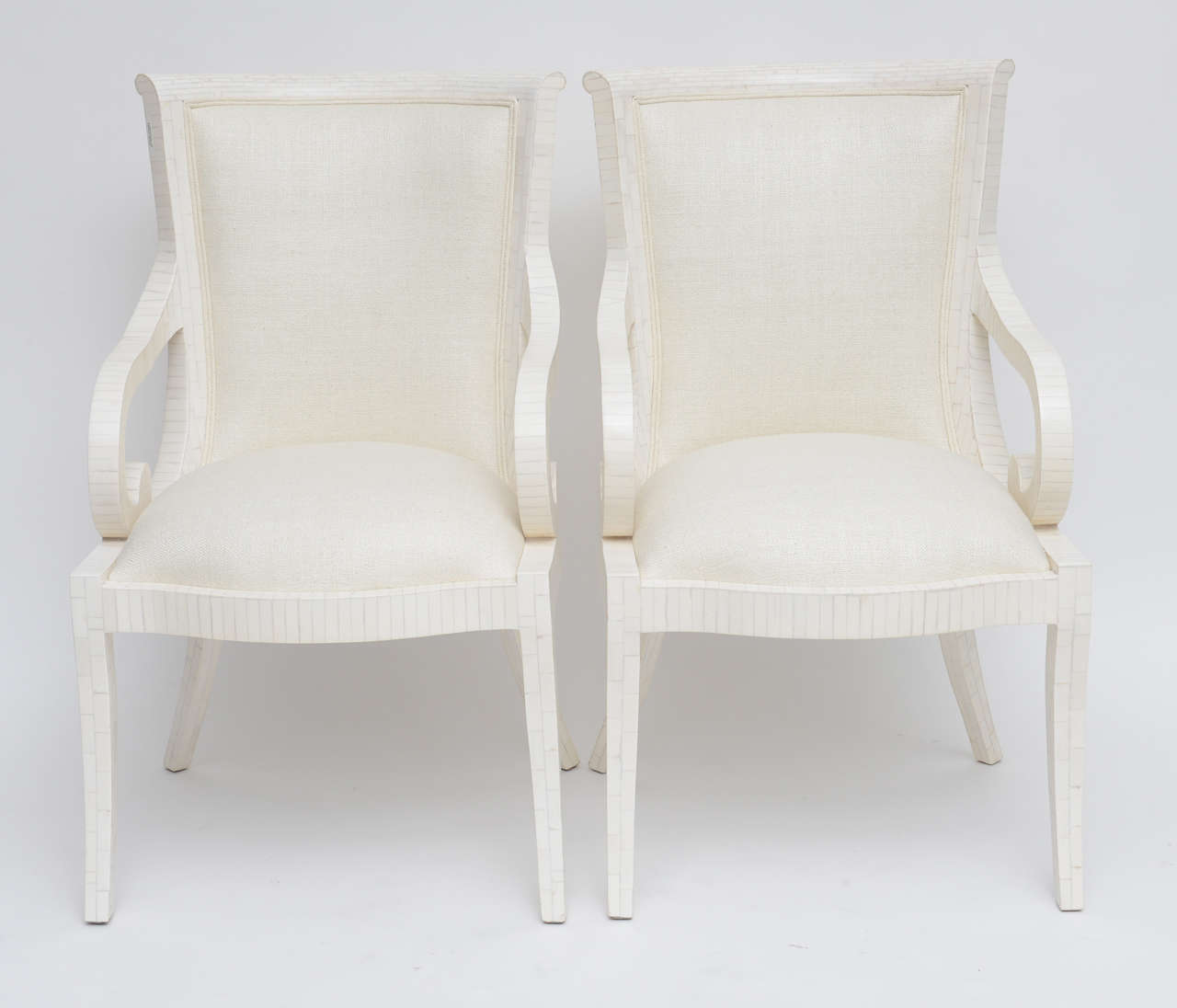 Immaculate, professionally restored pair of tessellated bone armchairs by Enrique Garces, upholstered in a soft cream silk. Please note that chairs are priced individually, not as a pair.