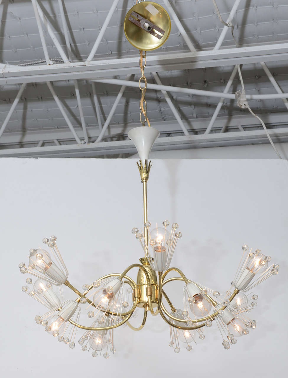 Lovely 12-arm brass and Austrian cut crystal snowflake chandelier, designed by Emil Stejnar for Rupert Nikoll, Vienna, circa 1955. Professionally polished and re-wired for U.S.