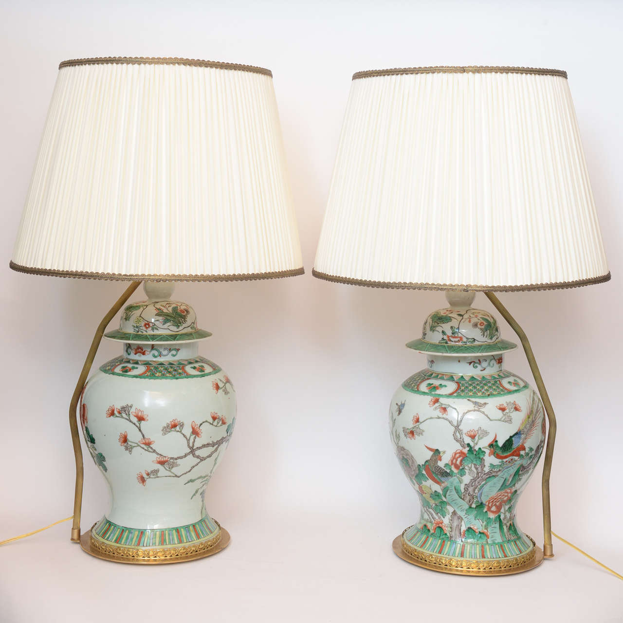 A pair of Chinese porcelain famille verte ginger jars with enamel paintings of birds and flowers and braches with blossoms. The vases aesthetically beautiful proportions and elegant, circa 1860.