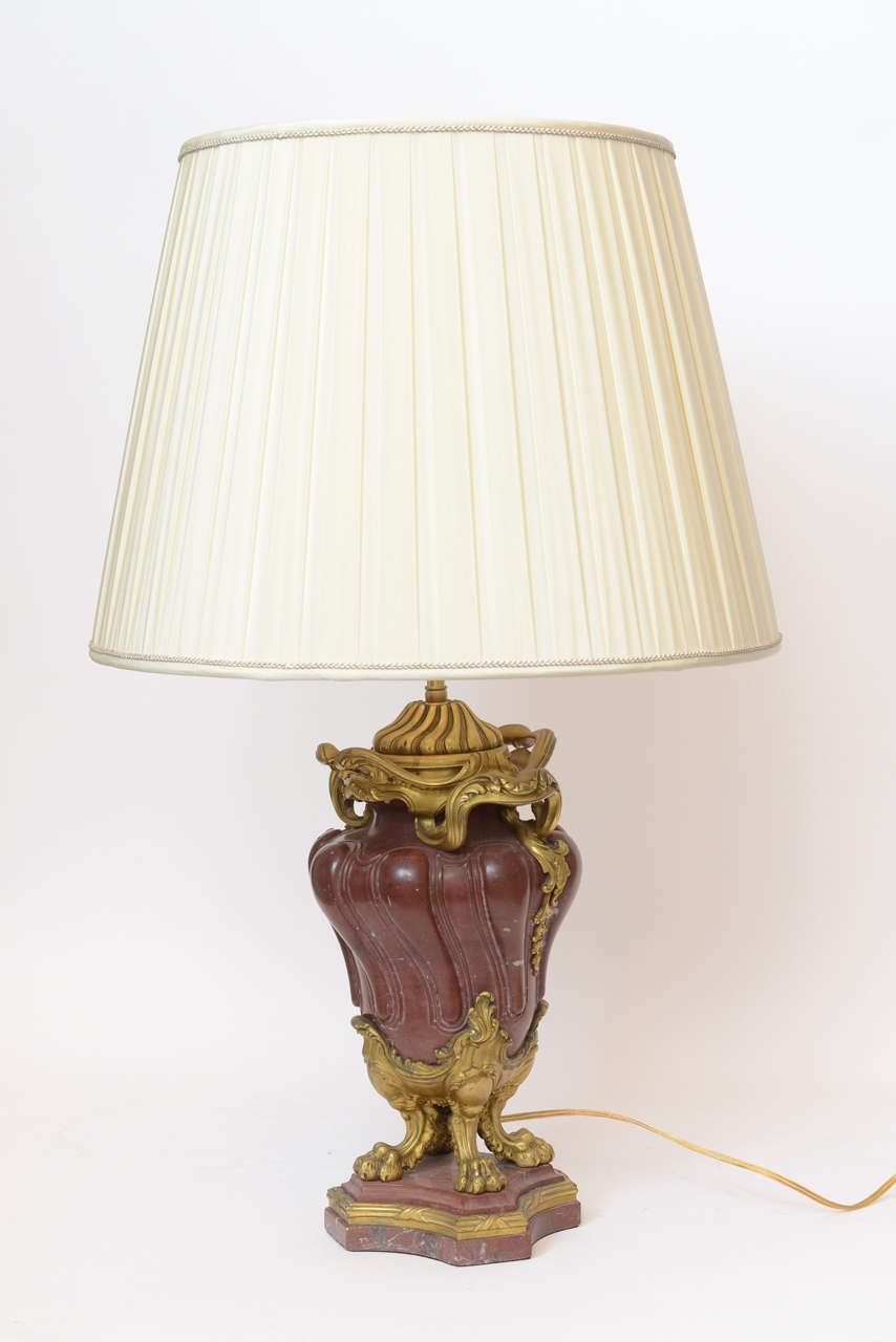 A pair of French spiral cut rouge marble lamps mounted with fine Rococo gilt bronze décor on paw feet, stamped Colin & Cie, foundry, Cachet, circa 1880.