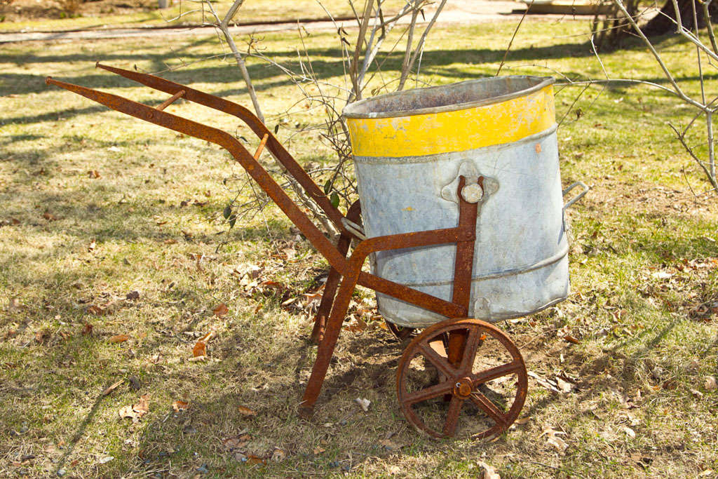 This little beauty was placed underneath the eaves of a manor house to collect rainwater and then trundled about the estate to water the gardens.  The original wrought iron frame is in wonderful condition and the galvanized steel bucket features its