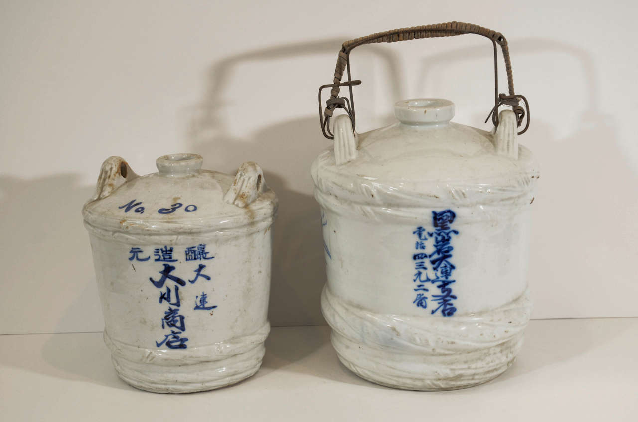 Antique porcelain Japanese wine jars found in China. Great original color and decoration. 
Priced individually.
CR640, CR641. Larger piece is sold.  Left jar in main image is available.