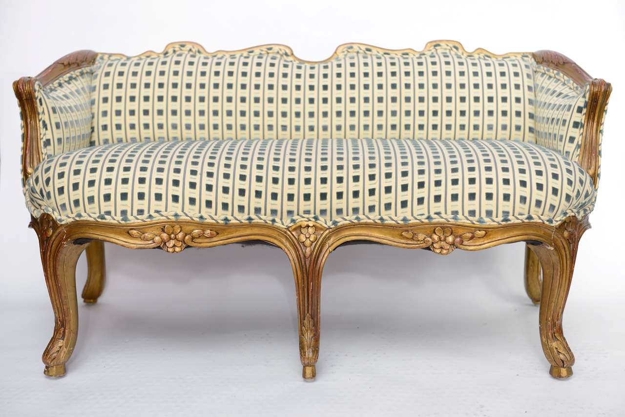 Charming child's sofa with hand-carved and gilded frame. Cut velvet and silk upholstery.