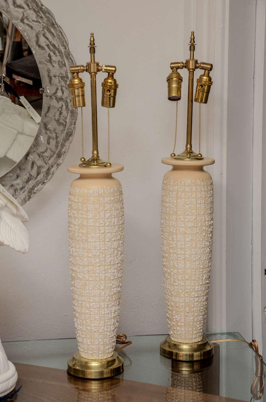 Pair of textured ceramic table lamps with brass accents.