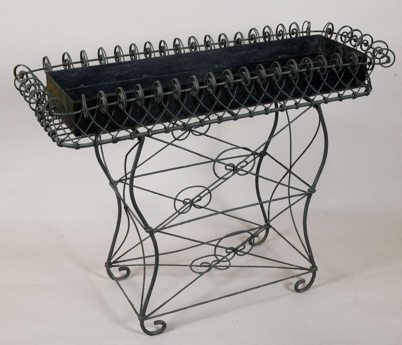 Two 1950s jardinières by Pierre Lottier, a French decorator, with metal tubes worked by hand. Iron container for water reserve with ring to pullout.