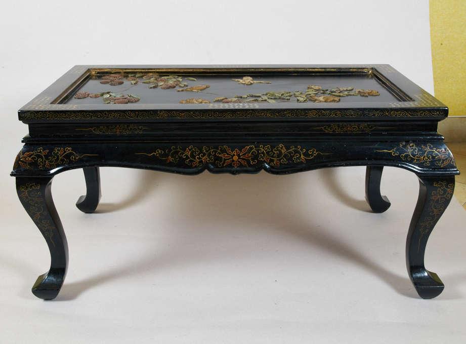 1900s Chinese lacquered coffee table with top surface decorated with pietre dure motifs; mother-of-pearl incrustations. Legs fold underneath top surface (see photos).