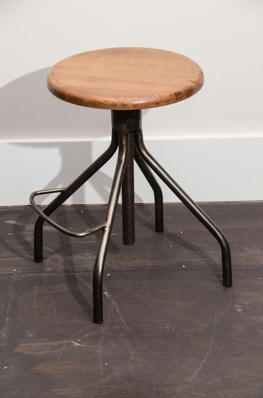 Industrial Stool - Steel base with Footrest and wooden top which screws up or down to adjust.