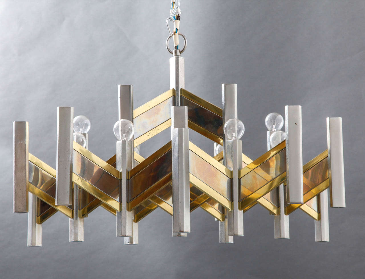Large scale chrome and brass chandelier by Gaetano Sciolari zig zag design body with 21 lights.
Suspended with chrome chain, labeled Sciolari Italy.