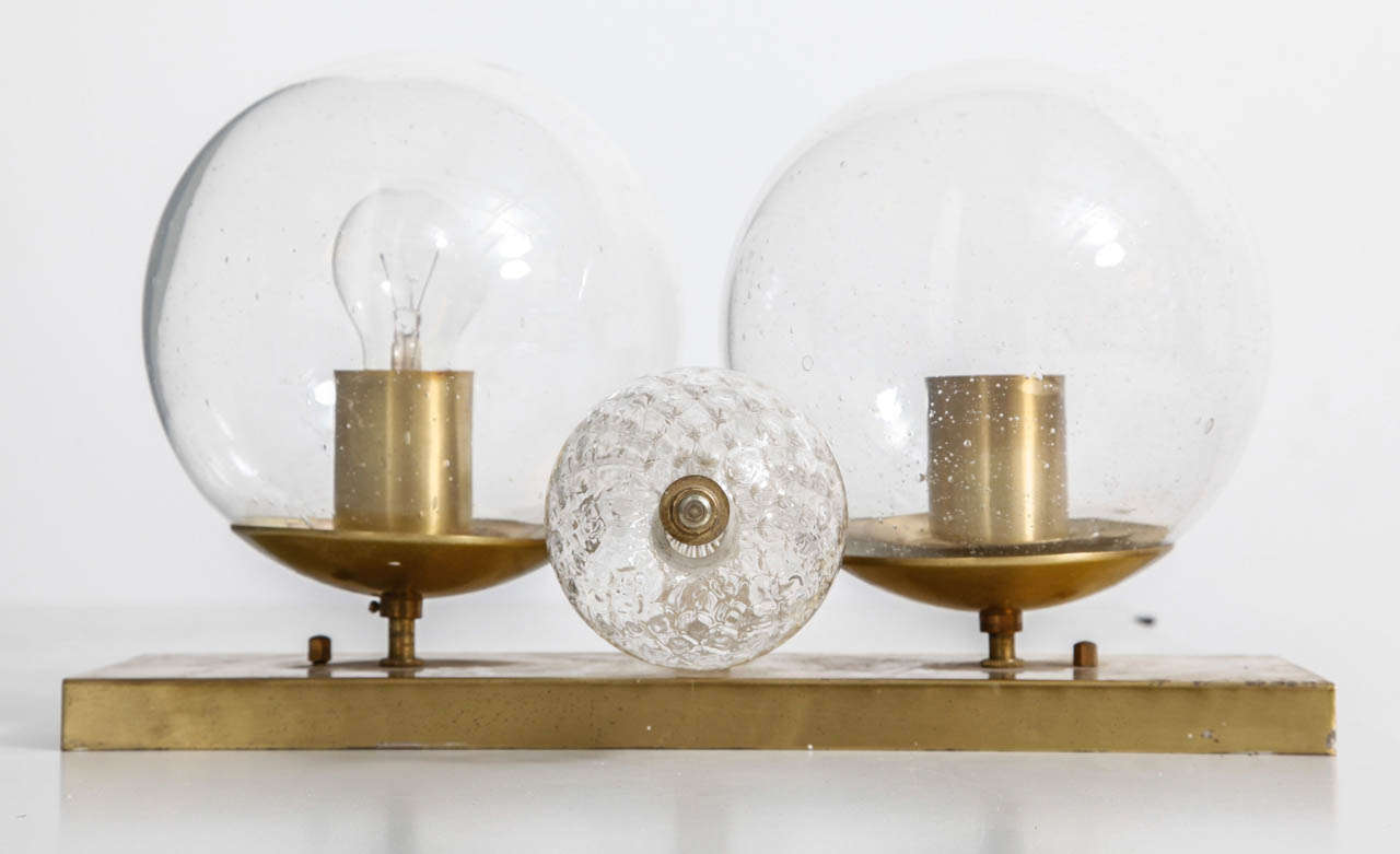 A set of Brass 1970's Glass Globes Wall lamps.
