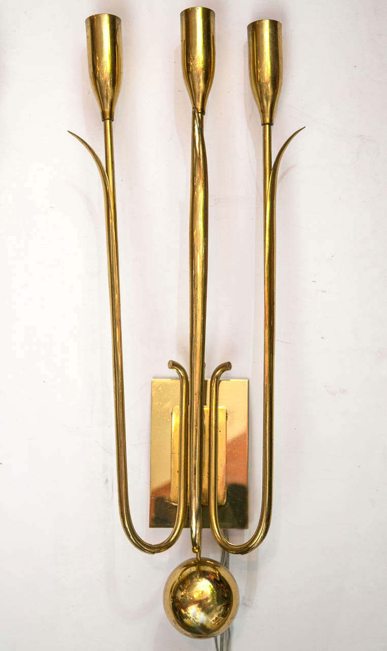 A pair of unique stylized tulip form wall sconces. Each has three electrified arms.