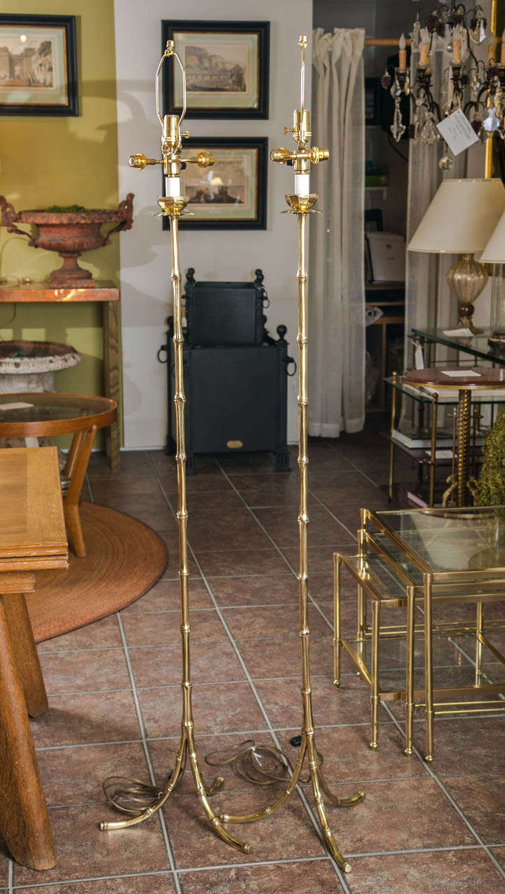 Pair of bagues bronze faux bamboo floor lamps on a tripod base with a decorative lotus flower socket