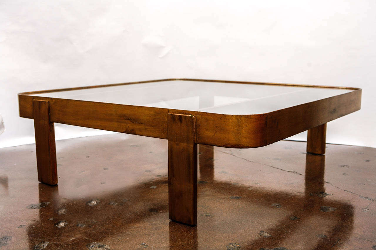 Large gilded mahogany frame cocktail table with glass top, designed by Paul Laszlo- from a Brentwood, California estate, circa 1954.

Original custom finish.