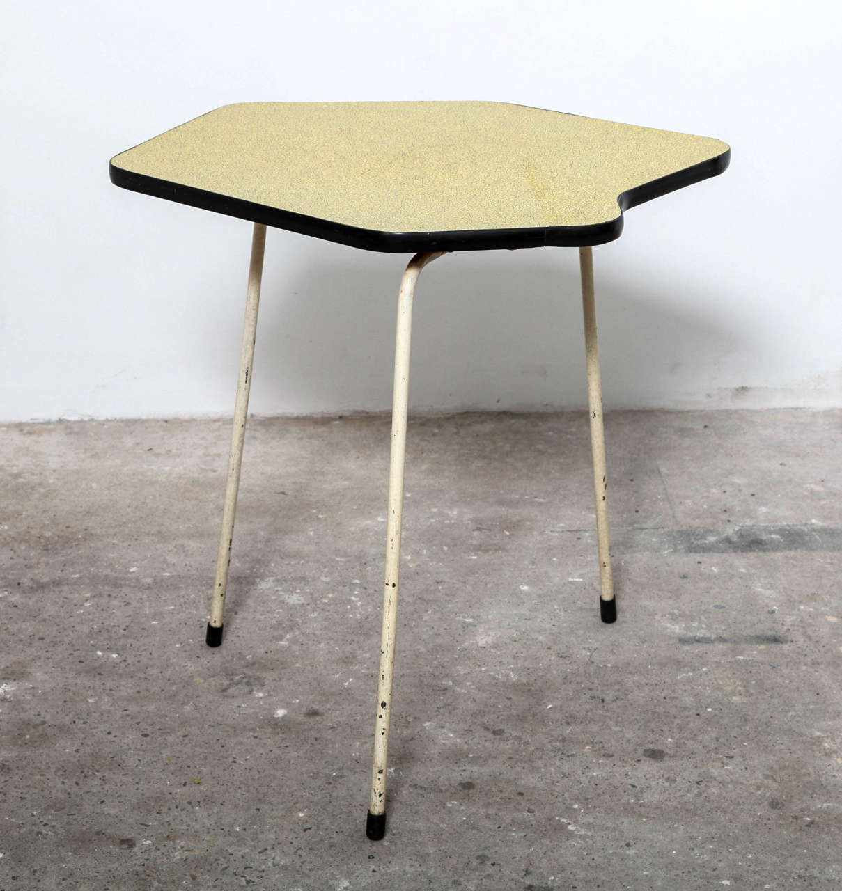Very nice piece of Belgium Industrial Design. A rare side table designed for Tubax in 1950s. The table has a very nice decorated top and are based on three heavy white lacquered solid metal legs. Collectors item in original vintage condition.