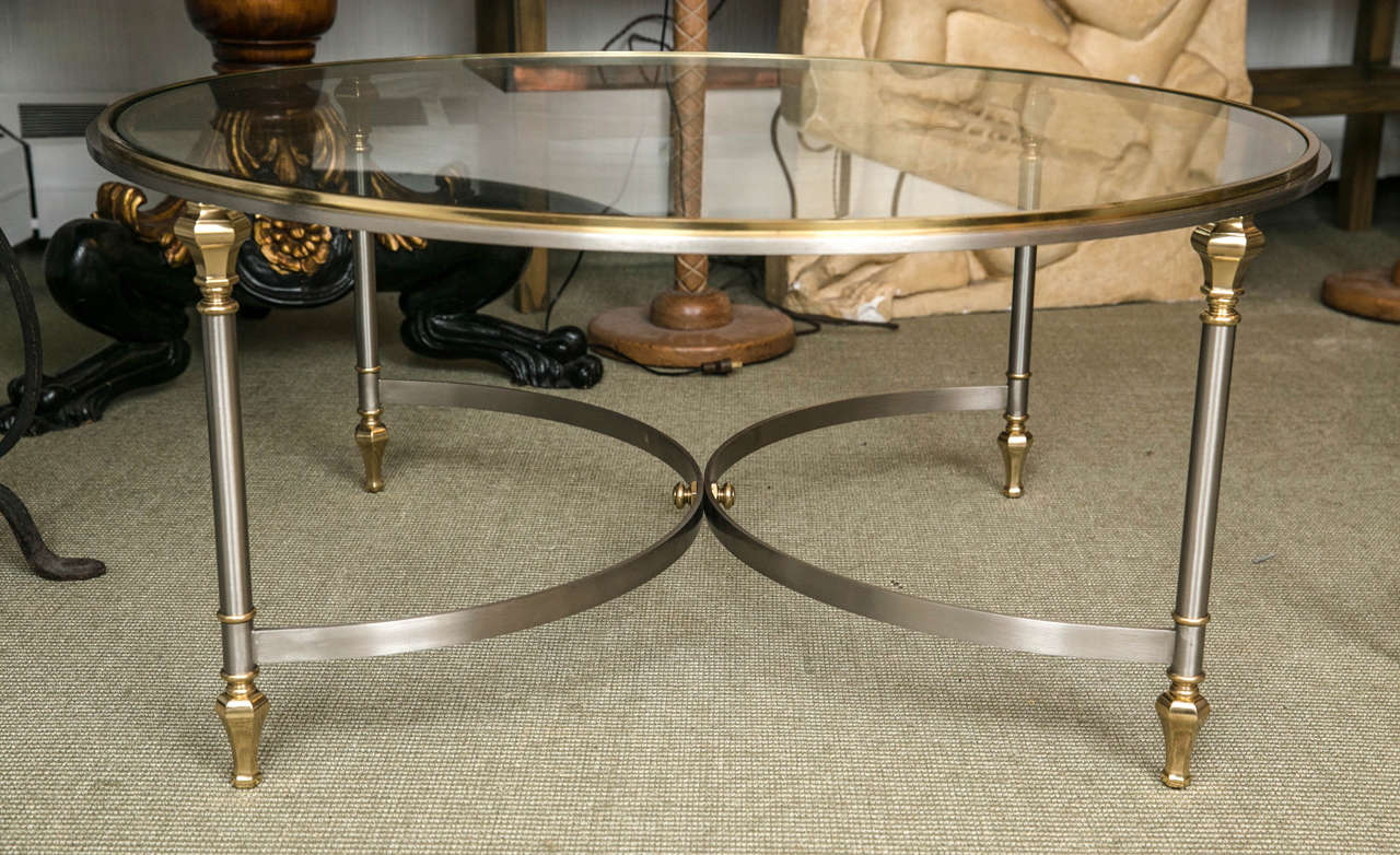 Directoire style bronze coffee table, having glass top supported on column form legs with shaped stretchers.