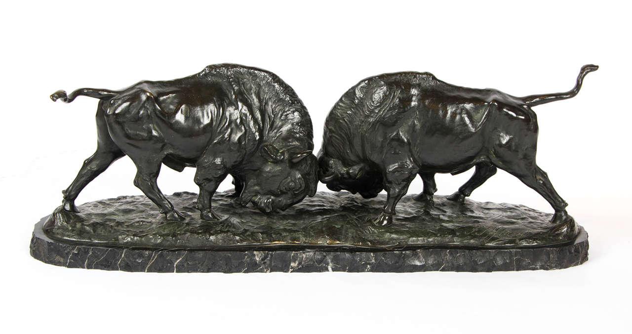 Kampfende Bisons ( Battling Buffalo) by Franz Iffland (1862-1935)
A pair of rich green/brown patinated bronze buffalo in full charging battle, set on a naturalistic integral base over a marble plinth.
Signed F. Iffland to base.