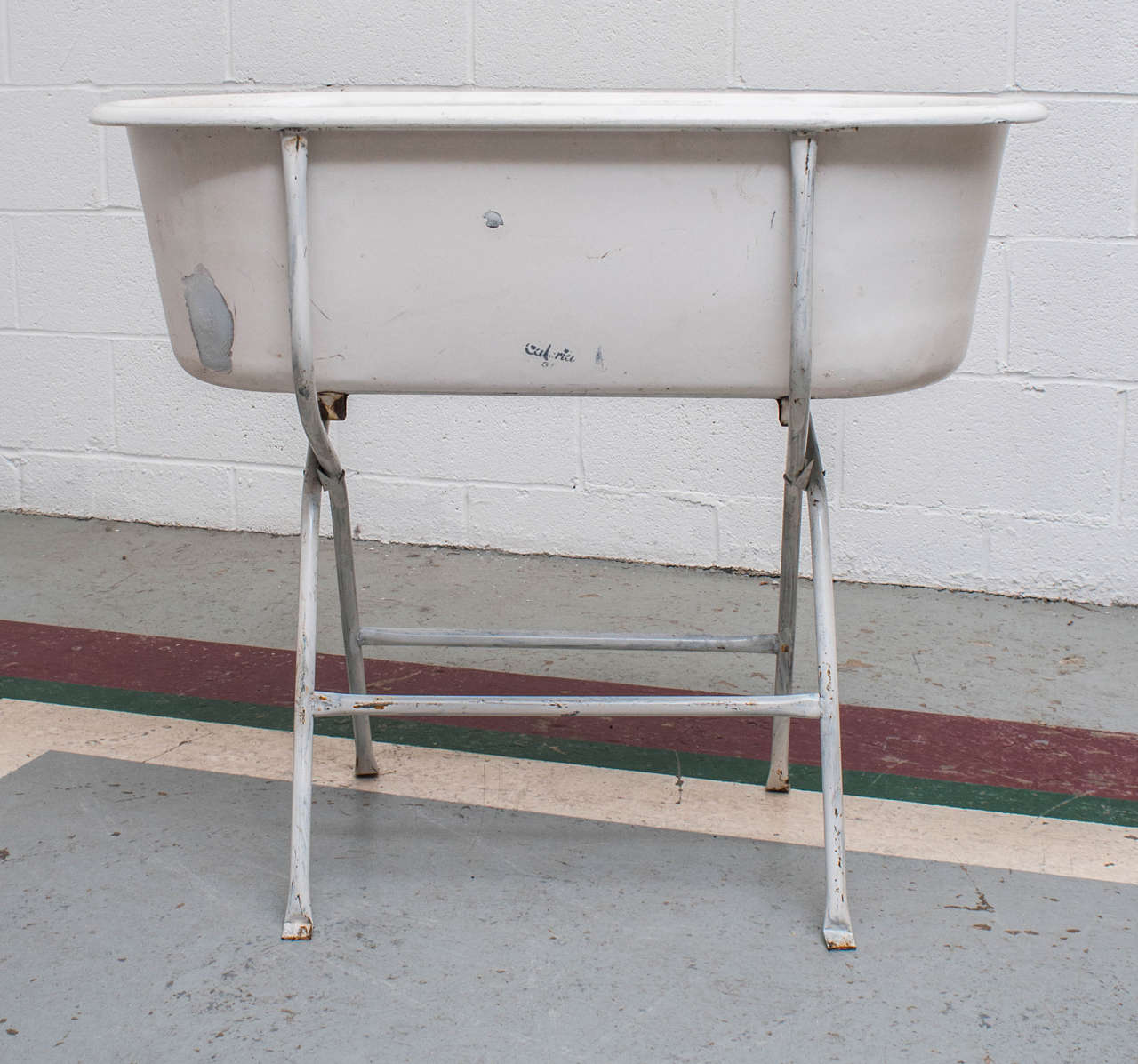 A vintage enamel baby bath on tubular stand. Great as a planter or as a wine and beer cooler at a summer party.