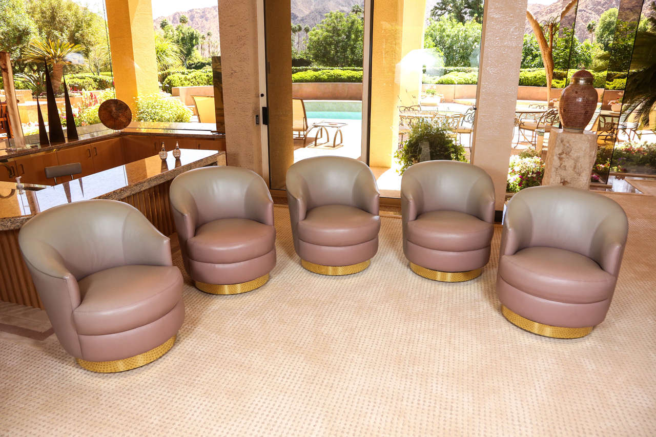 Spectacular leather swivel chairs designed by Steve Chase.
These stunning gray / mauve ombre leather swivel chairs are in the original custom Chase leather and retain the original Chase tags. 
The chairs have a wide brass band around the bottom