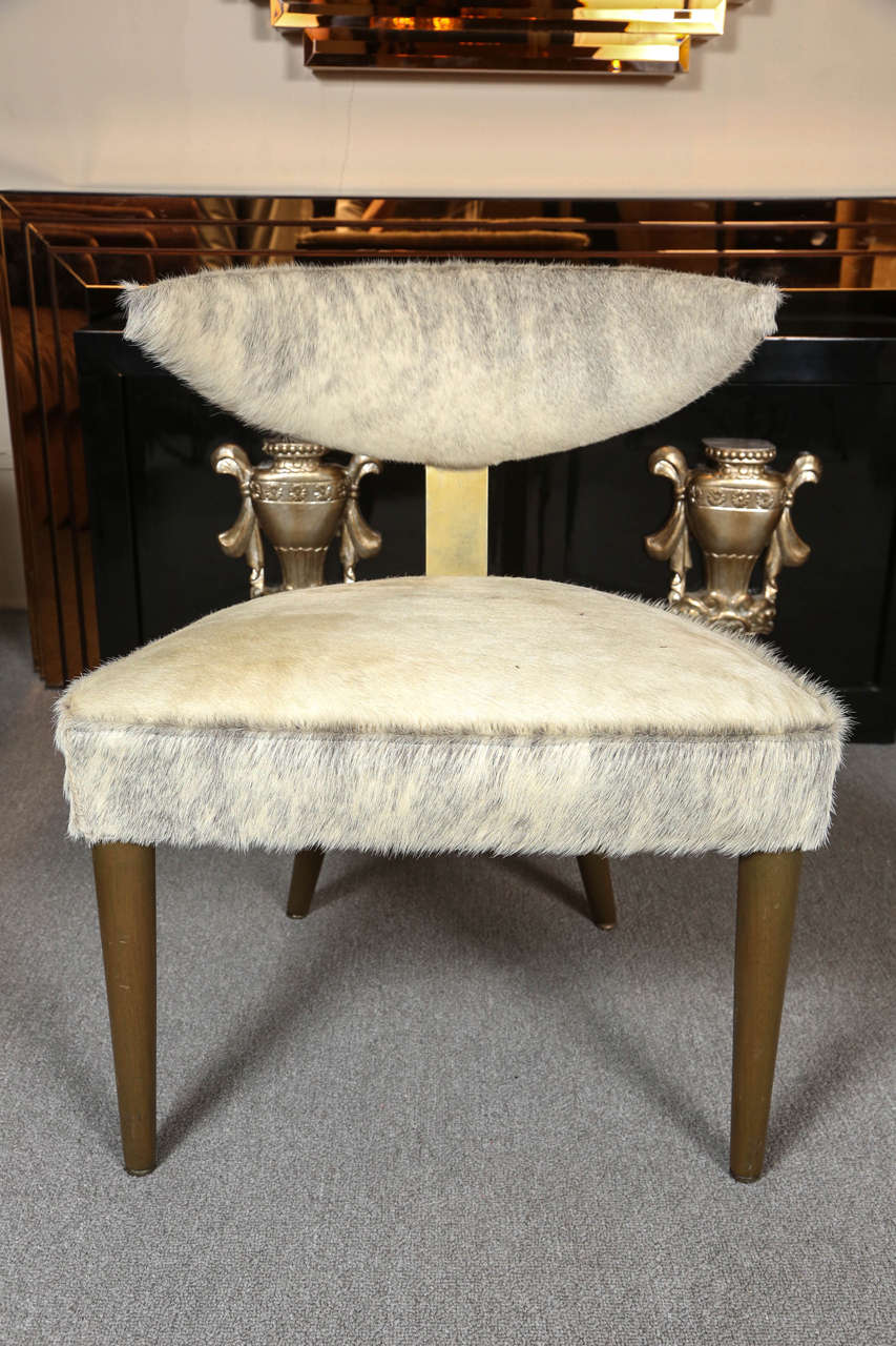 Pair of elegant side chairs designed by Maurice Bailey for Monteverdi-Young.
The chairs have an olive colored stained finish which is complemented by a brass centre back plate and cowhide upholstery.