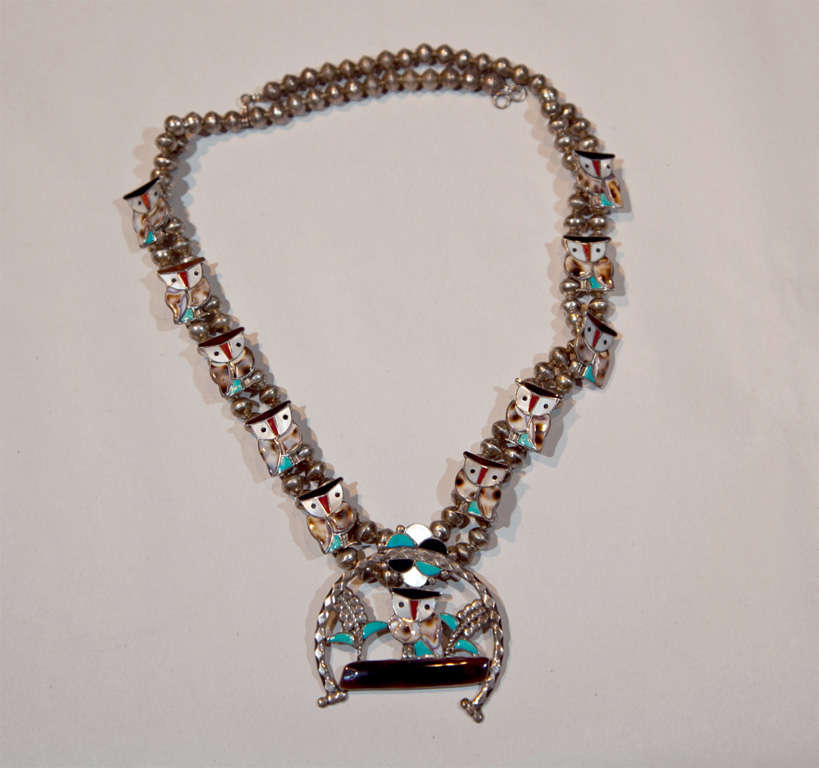 This beautifully crafted American-Indian necklace flaunts sweet owls made of turquoise and coral.