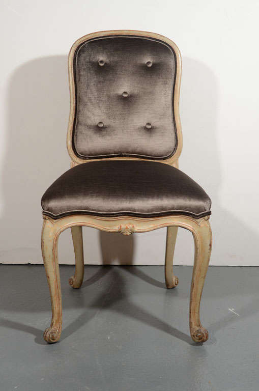 Elegant distressed painted Provincial
chair with hand-carved wood frame.
Chair has cabriole leg design and
has been newly upholstered in a rich
sable colored velvet with button back
details. Size is ideal for a vanity or
desk, or as a side