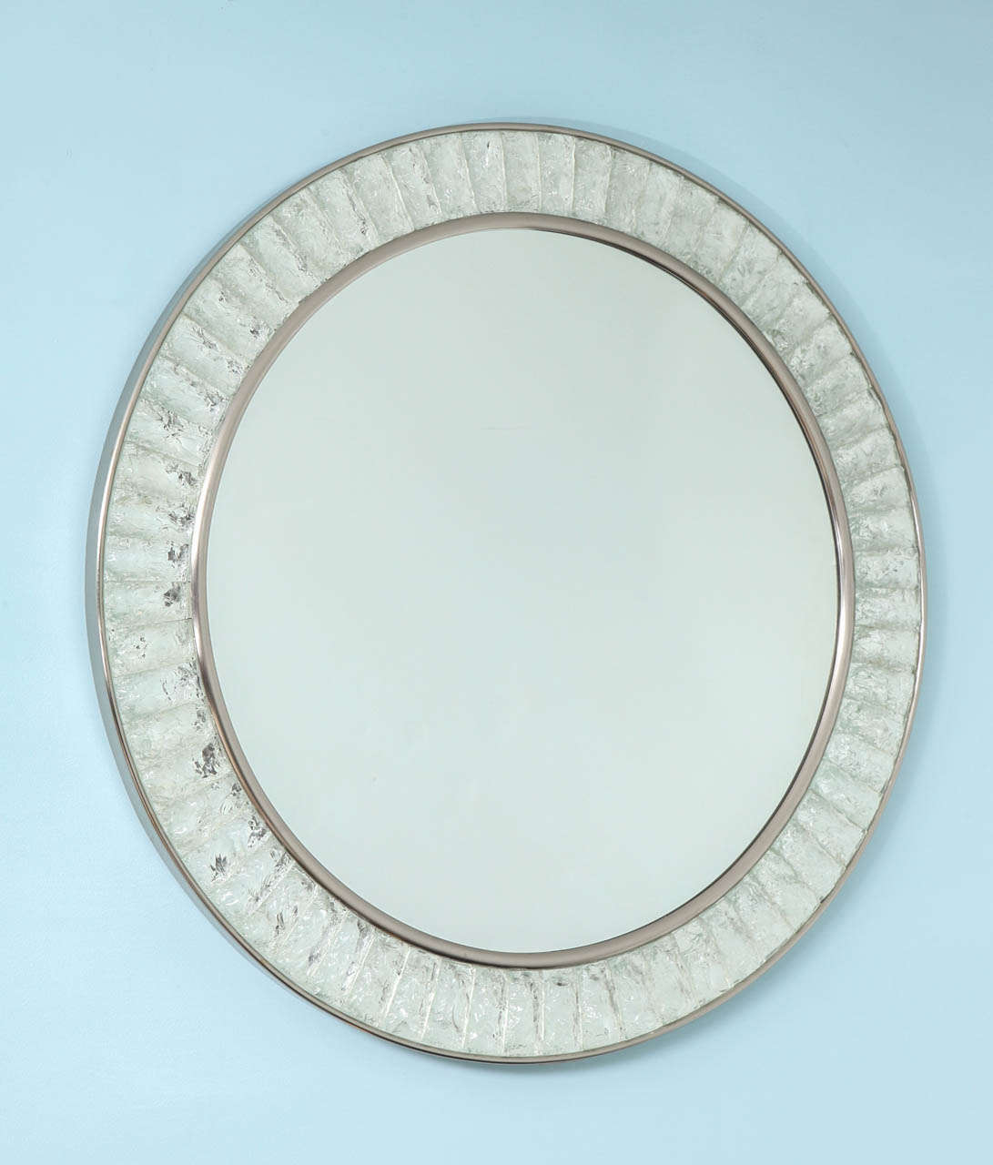 Circular mirror with brushed nickel mounts.  Features blcoks of chiseled crystal, inset into the frame.  Each piece is hand cut, and shaped to custom fit this piece.  A beautiful example of contemporary Italian studio work.
