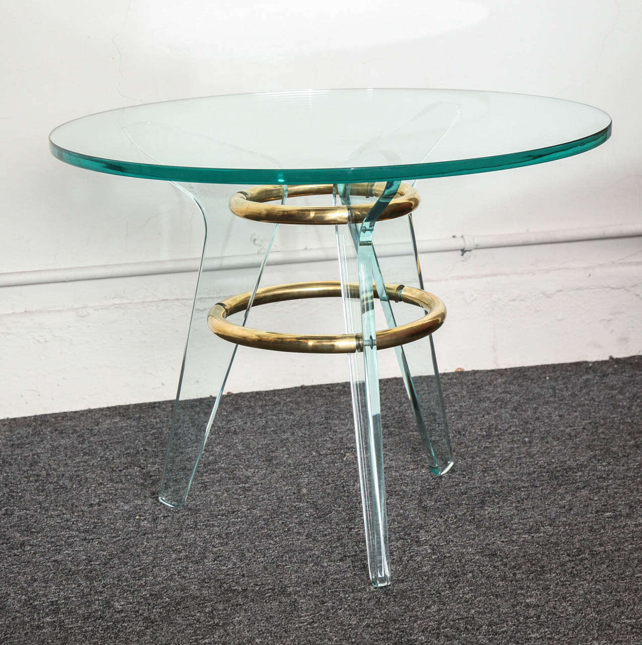 STUNNING ROUND COCKTAIL / SIDE TABLE MADE IN MILAN 1940'S, VERY UNUSUAL FORM IN THAT IT HAS 2 BRASS RINGS THAT CONNECT THE 3 GLASS LEGS TO FORM THE BASE of THE TABLE, BEAUTIFULLY MADE.