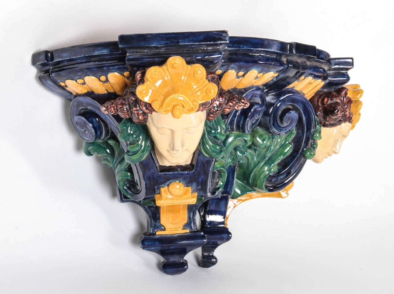 Eugene Schopin (1831-1893) Montigny-sur-Loing, France.

Renaissance-Revival style Majolica wall shelf, circa 1872.

Hand modeled and cast ceramic with highly stylized caryatids and floral details glazed with rich cobalt blue, green, gold and