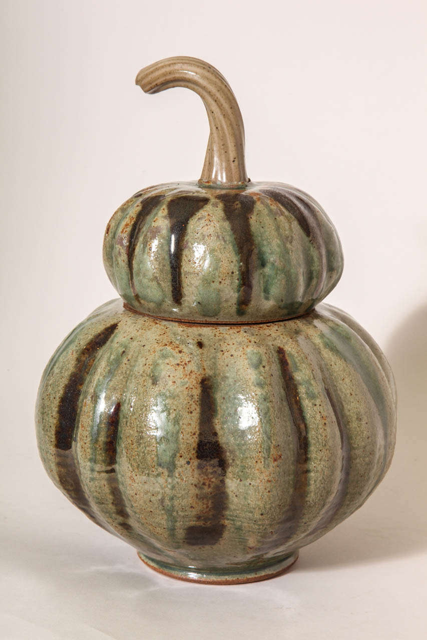 Ceramic covered box in shape of gourd with lid with twisted stem.
Signed: Greg Kuharic and dated 2002.