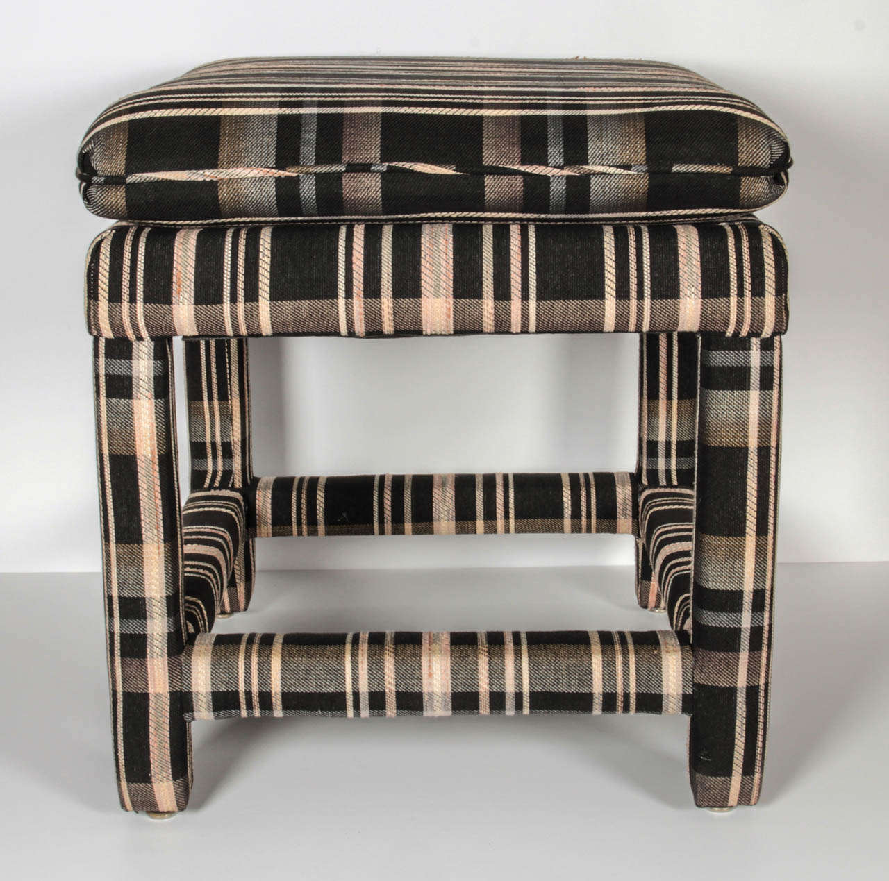 An upholstered stool with original fabric.