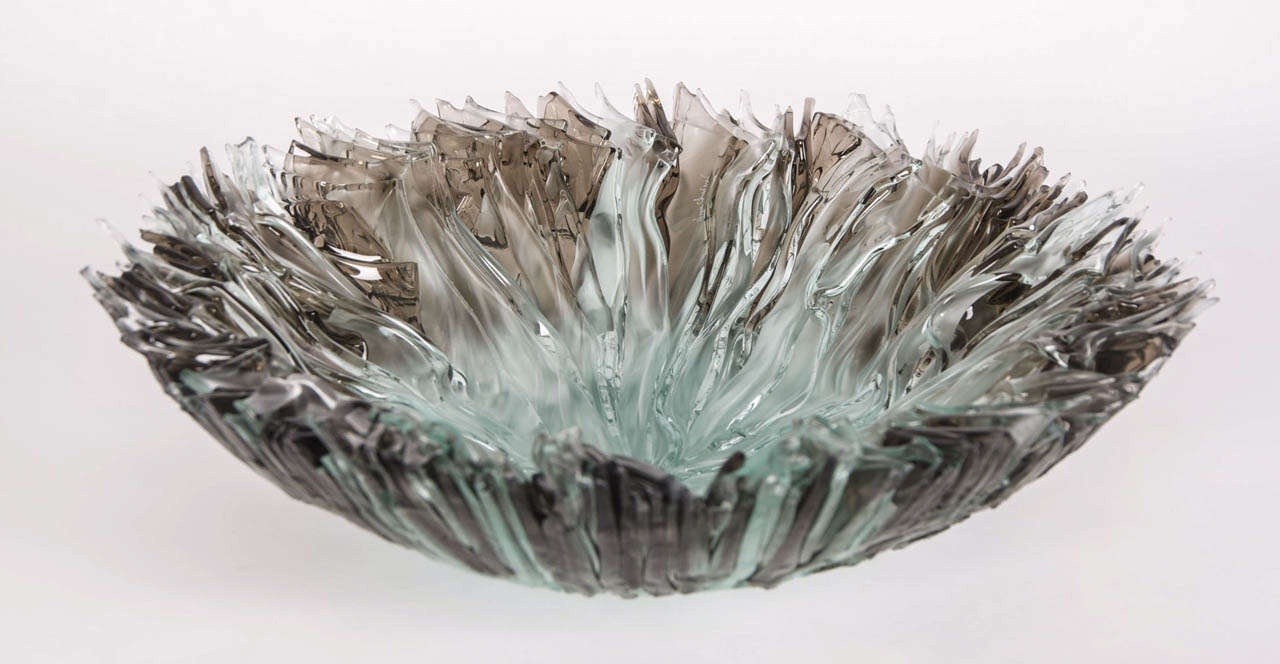 Bloom Bowl in Bronze, is a bronze and clear glass centrepiece by the British artist Wayne Charmer.

For Wayne Charmer, the fascination of glass is to exploit it’s translucent and reflective qualities. Inspired by nature, his signature techniques for