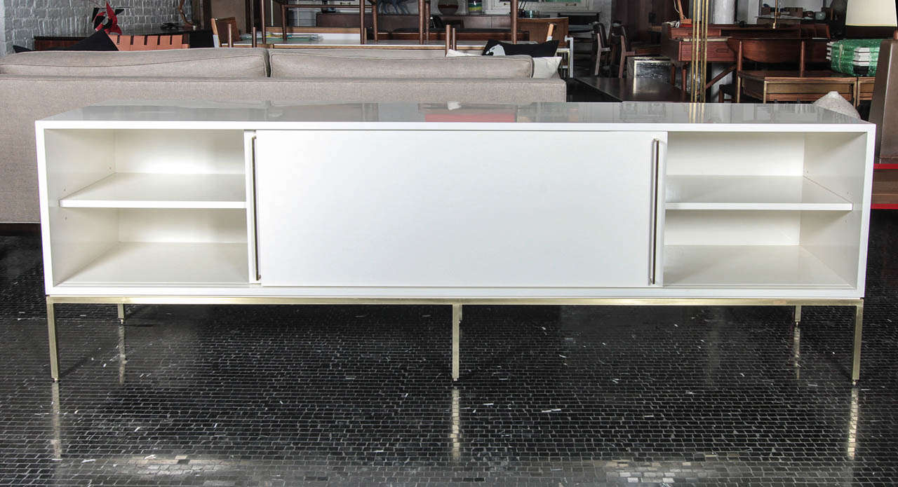 Mid-Century inspired credenza series from reGeneration.  Available in a range of colors, on brass, satin stainless steel or powder coated bases. Email for a current list of in stock colors.